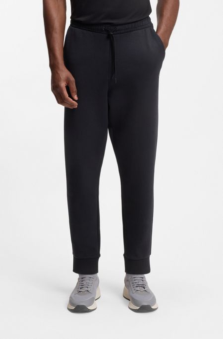 Stretch-cotton tracksuit bottoms with logo print, Dark Blue