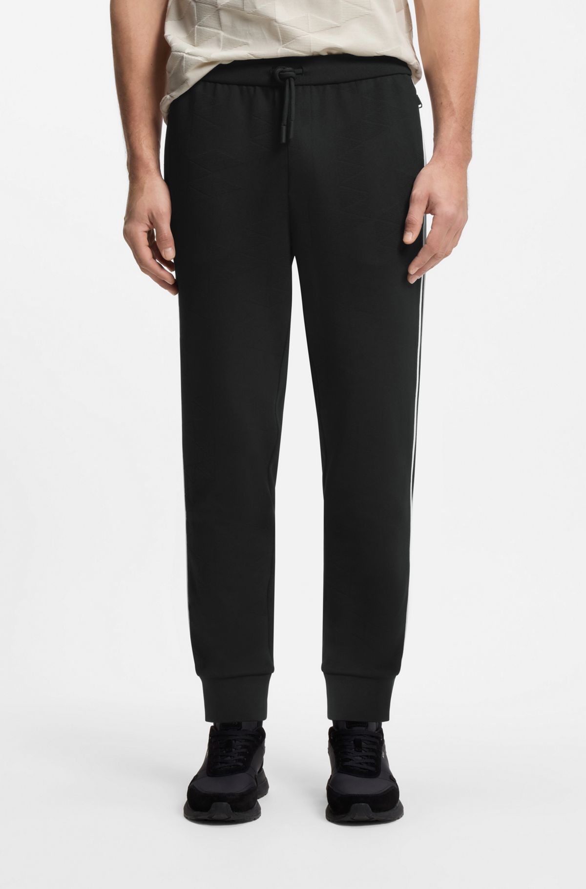 Triangle-jacquard tracksuit bottoms with rubberised logo, Black